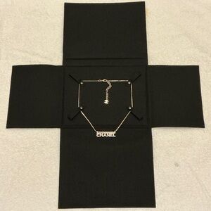 CHANEL Gold Necklace with Logo Charm